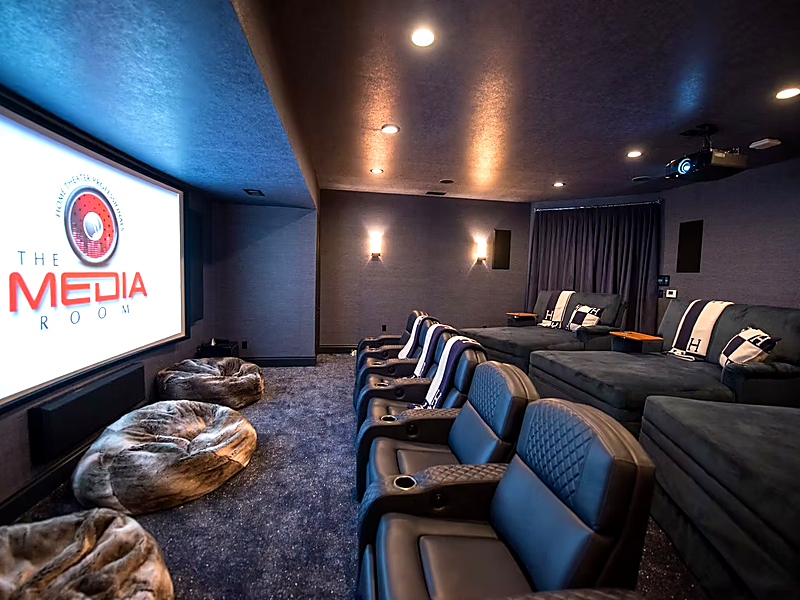 Custom Dolby Atmos home theater with projector screen and luxury seating in Calabasas