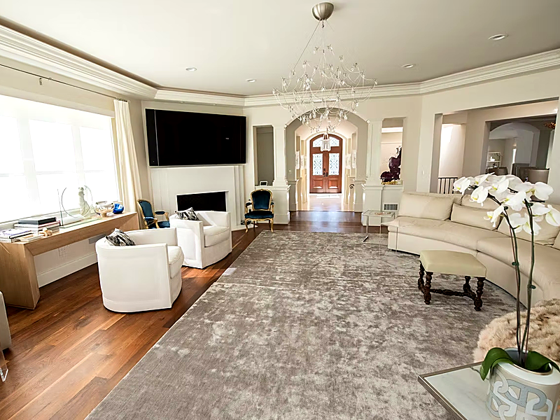 Elegant living room with large wall-mounted TV and designer furnishings in Hidden Hills