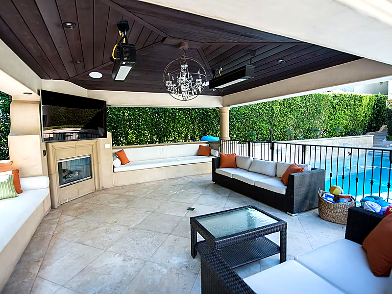 Outdoor entertainment cabana with TV, speakers, and pool in Agoura Hills